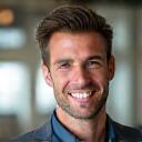 Smiling man, Marcus T., with a clean-shaven face and confident expression